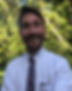 Mr. Mitch has a big grin with a beard while wearing a white collared shirt and tie 