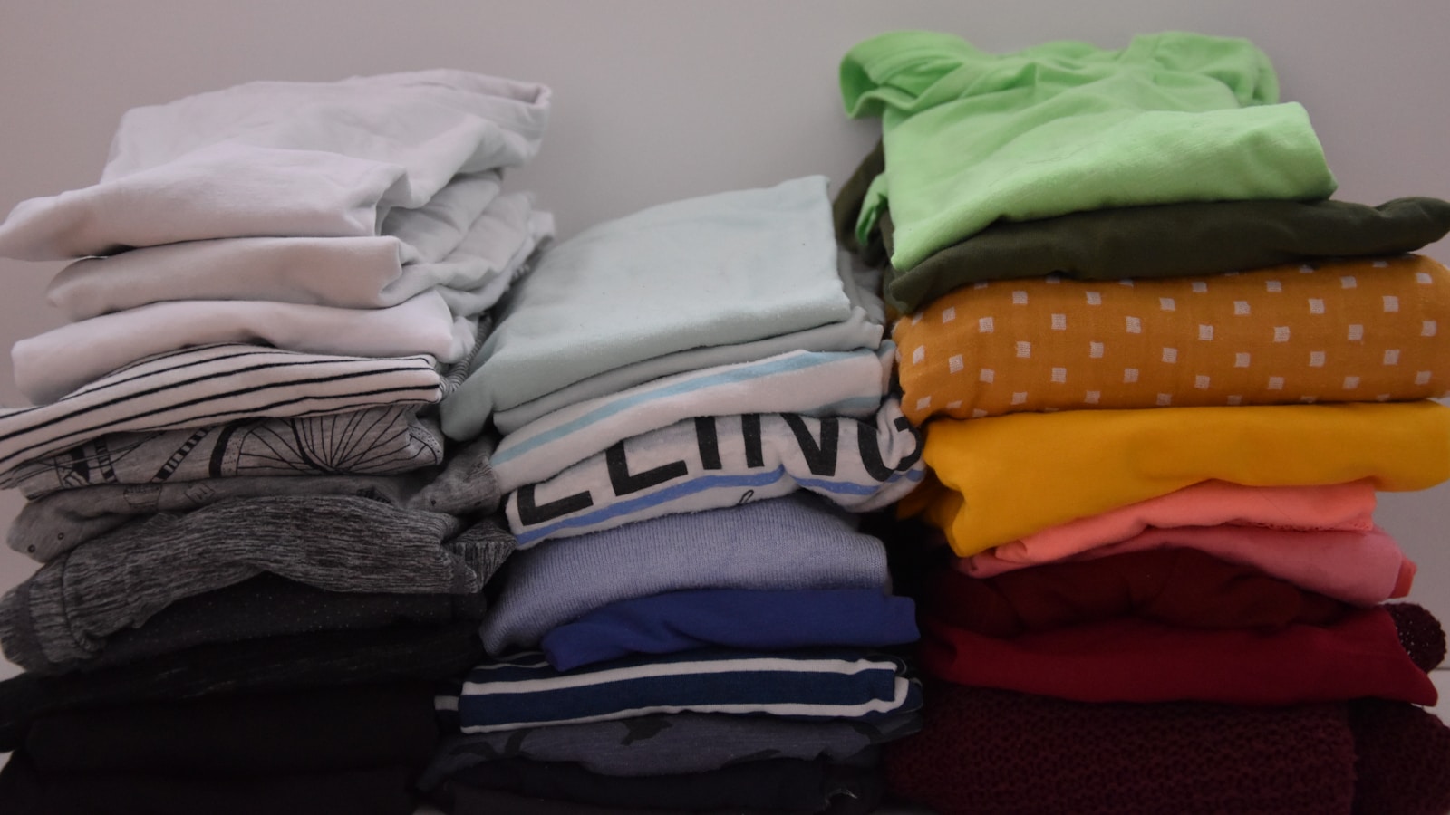 stacked piles of tshirts