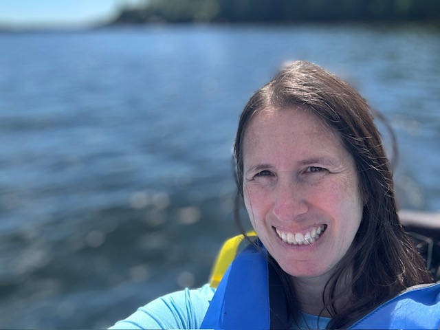 Selfie of Amanda in life jacket on a lake
