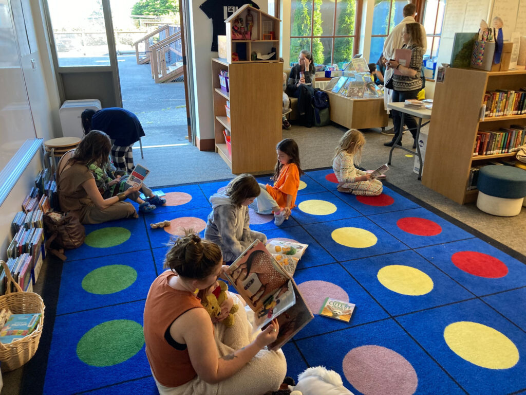 Kids reading on the dotted library rug