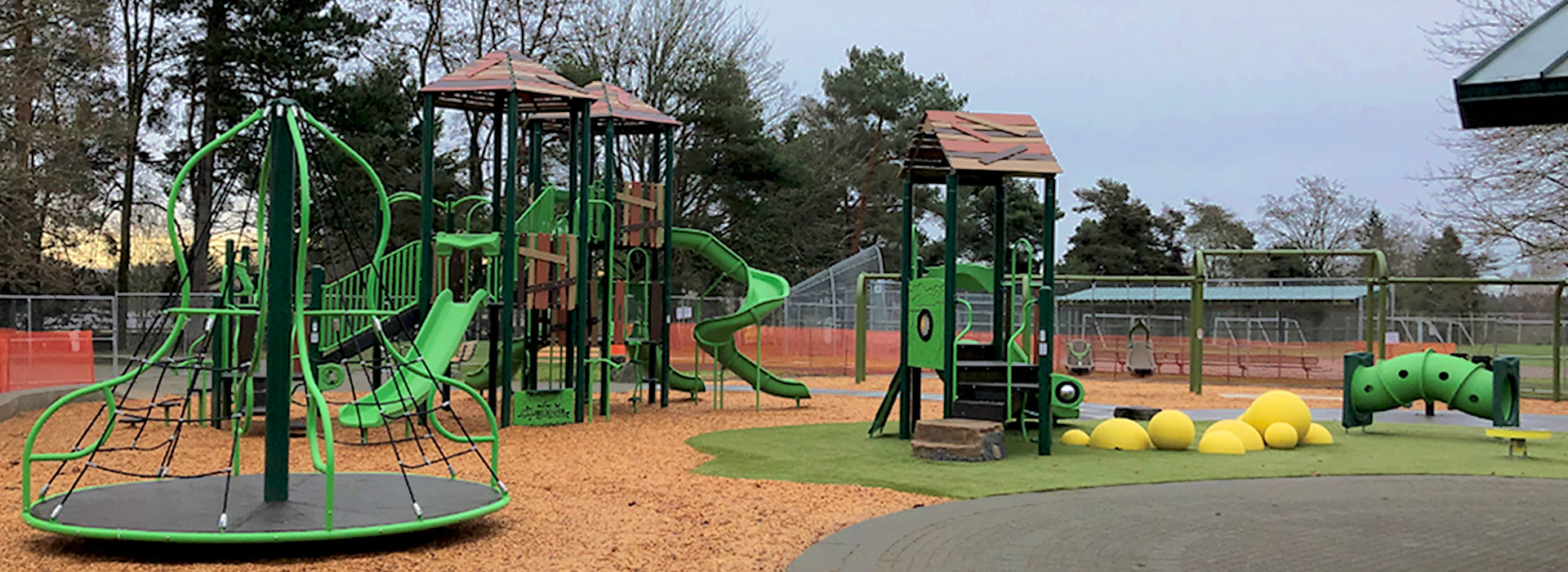 Bright green playground with slides and merry-go-round